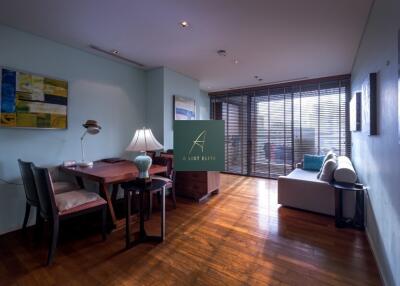 Spacious living area with wooden flooring and large windows