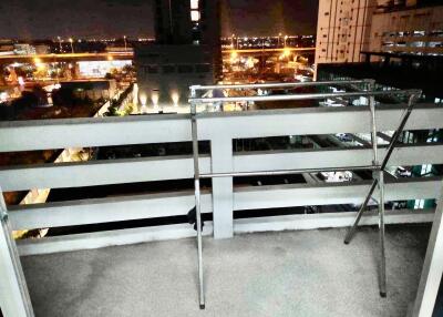 Night view from a balcony with railing and drying rack