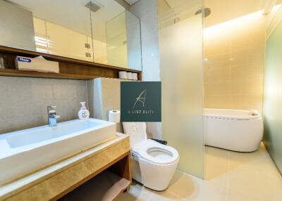 Modern bathroom with sink, toilet, and bathtub