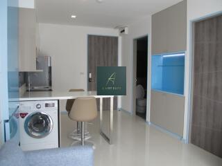 Modern kitchen with adjacent storage space and sitting area