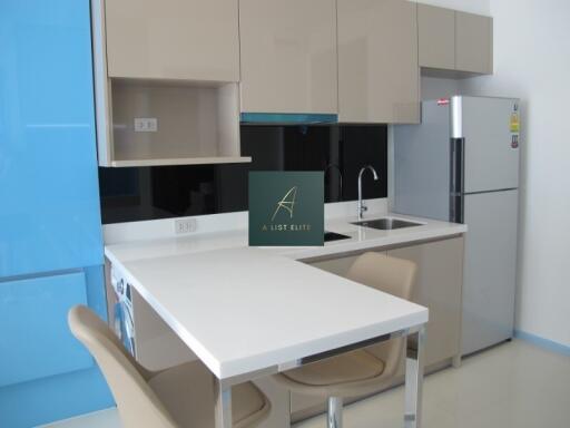 Modern kitchen with beige cabinets and white countertop