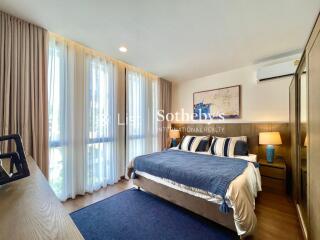 Modern bedroom with large windows and natural light