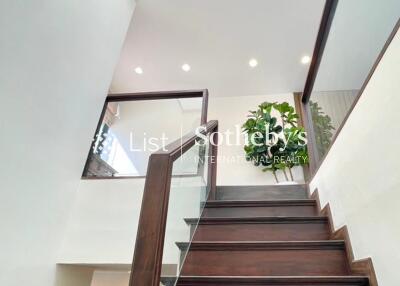 Modern staircase with wooden steps and glass railing