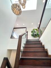 Modern staircase with wooden steps and glass railing