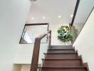 Modern staircase with wooden steps and glass railing