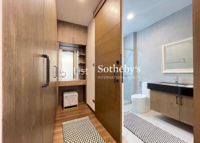 Modern bathroom with wooden accents, sliding door, and vanity area