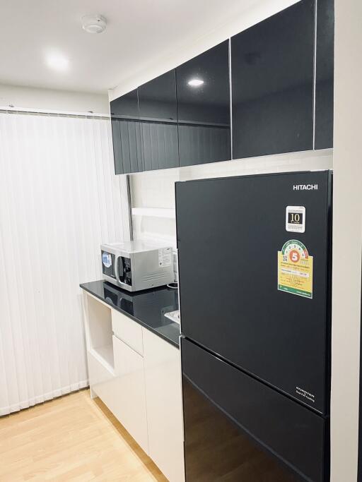 Modern kitchen with black appliances and white cabinets