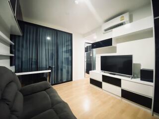 Modern living room with black and white furniture and a TV set