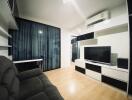 Modern living room with black and white furniture and a TV set