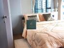 Modern bedroom with a neatly made bed, large windows, and decorative pillows.