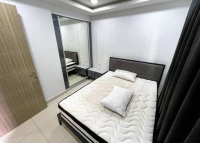 Modern bedroom with mirrored wardrobe and double bed