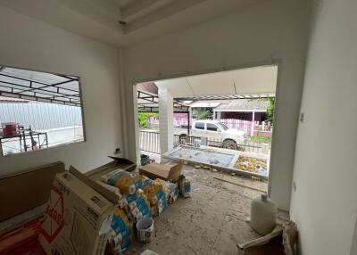 Partially renovated room with supplies and view of exterior