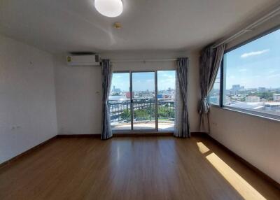 Bright, spacious living room with large windows and city view