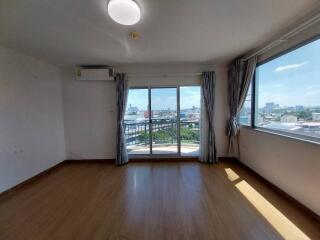 Bright, spacious living room with large windows and city view