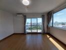 Bright, spacious living room with large windows and city view