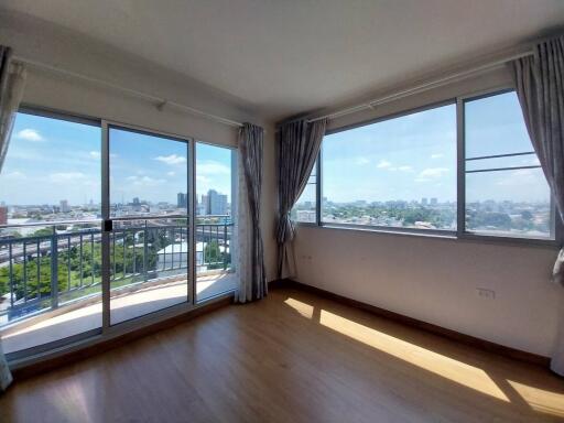 Bright living room with large windows and city view