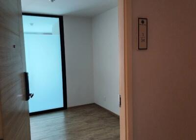 Entry view of a room with wooden flooring and frosted glass panel