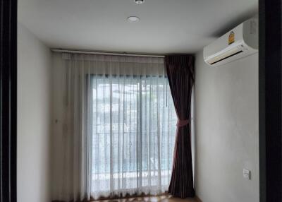 Bedroom with large window and air conditioner