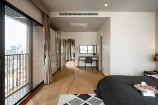 Modern bedroom with a workspace and a balcony view