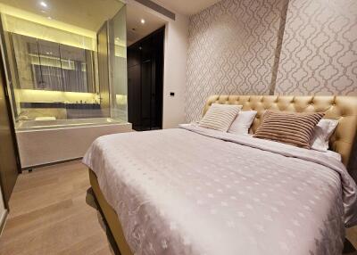 Modern bedroom with patterned wallpaper and en-suite bathroom