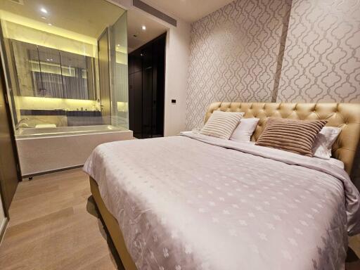 Modern bedroom with patterned wallpaper and en-suite bathroom