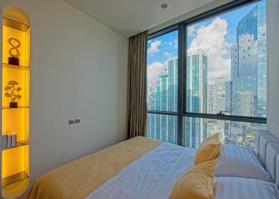 Modern bedroom with city view and built-in shelving