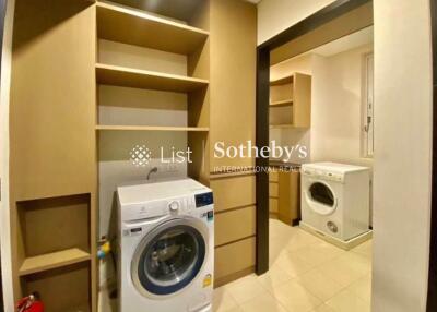 Laundry room with washer and shelves