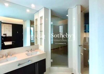 Modern bathroom with double vanity and glass-enclosed shower