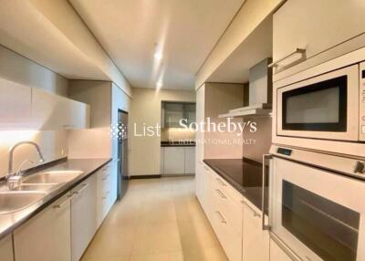 Modern kitchen with white cabinetry and built-in appliances