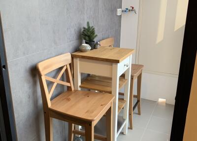 Small kitchen nook with wooden stools and a table