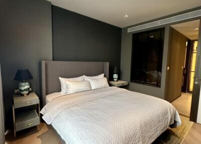 Modern bedroom with double bed, bedside tables, and soft lighting.