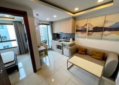 Living room with open kitchen and view into the bedroom