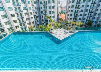 View of apartment buildings with a large outdoor swimming pool