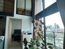 Modern duplex living room with large windows and plants