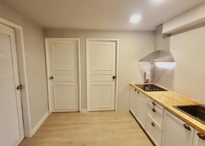 Modern kitchen with wooden countertops and white cabinets