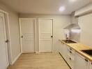 Modern kitchen with wooden countertops and white cabinets