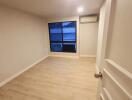 Empty bedroom with window and air conditioning unit