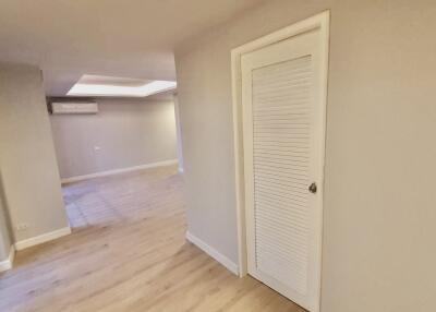 Modern living space with wooden flooring and a closet door