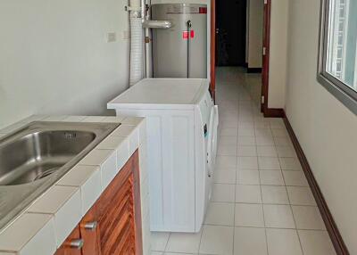 Laundry room with washing machine and sink