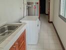 Laundry room with washing machine and sink