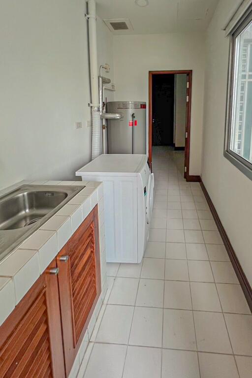 Laundry room with washing machine and sink