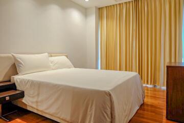 Cozy bedroom with white bedding and yellow curtains