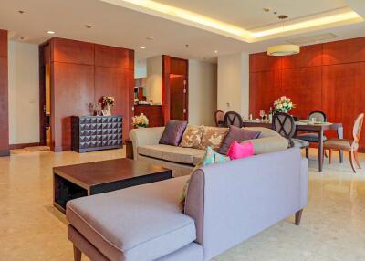 Spacious and modern living room with wooden accents and ample seating.