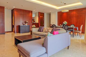 Spacious and modern living room with wooden accents and ample seating.