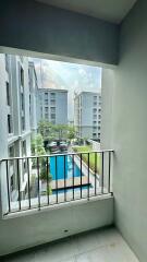 View from balcony overlooking building courtyard with swimming pool