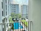 View from balcony overlooking building courtyard with swimming pool