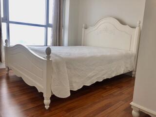 Bedroom with a large bed and wooden flooring