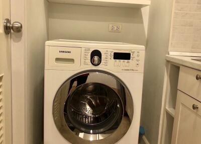 Compact laundry area with Samsung washing machine