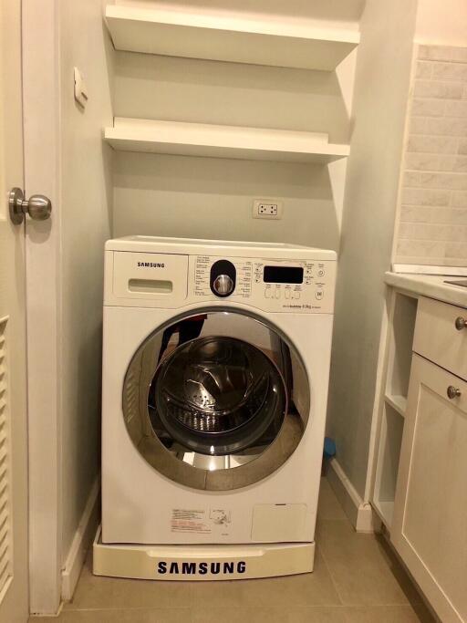 Compact laundry area with Samsung washing machine