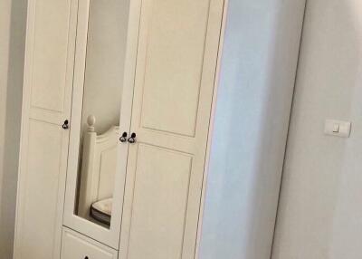 Large white wardrobe in a bedroom